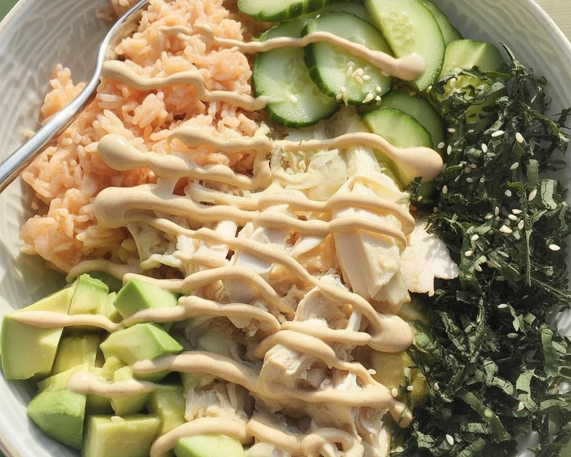 Delicious Salmon Rice Bowl topped with fresh avocado, cucumber, and veggies.