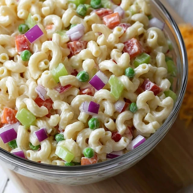 Bowl of simple macaroni salad with vegetables and dressing