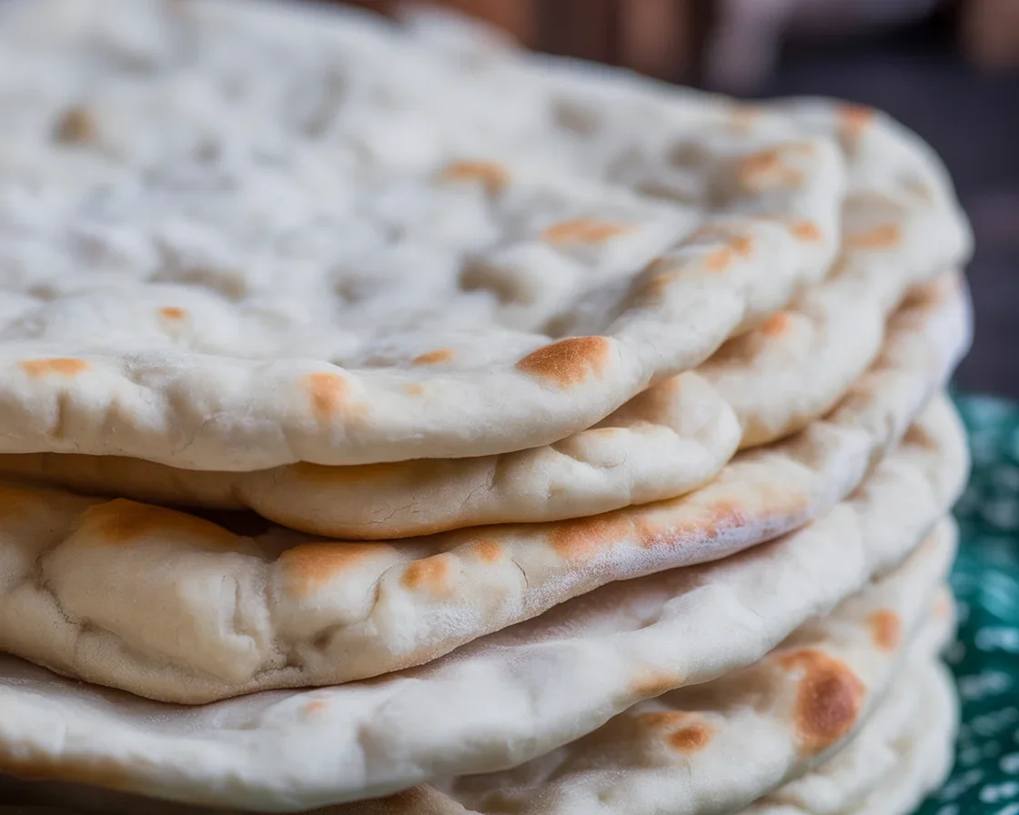 Homemade fresh pita bread, soft and fluffy, perfect for dipping and sandwiches.