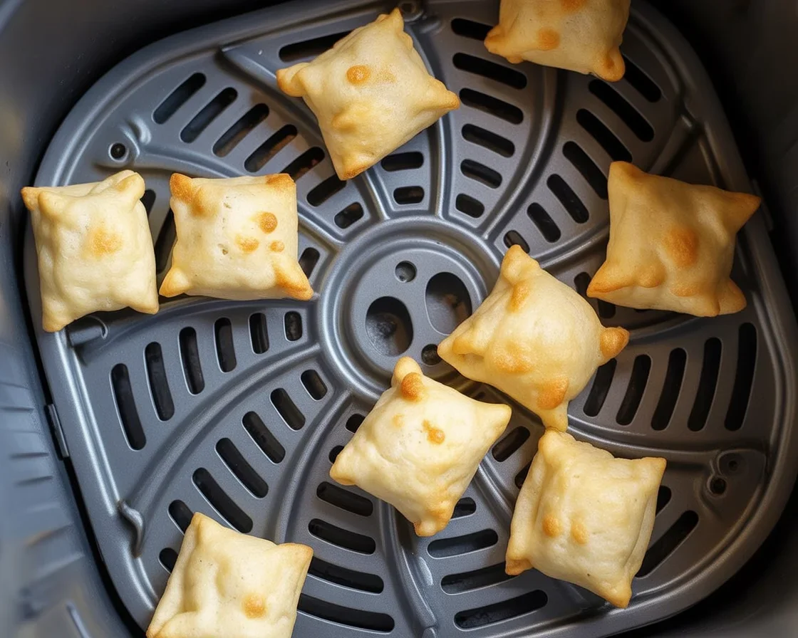 Golden and crispy air fryer pizza rolls served with dipping sauce.